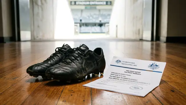 Football cleats resting on a floor next to a humanitarian visa document in soft light.