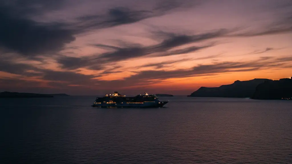 Cruise ship silhouette against a dramatic Santorini twilight sky.