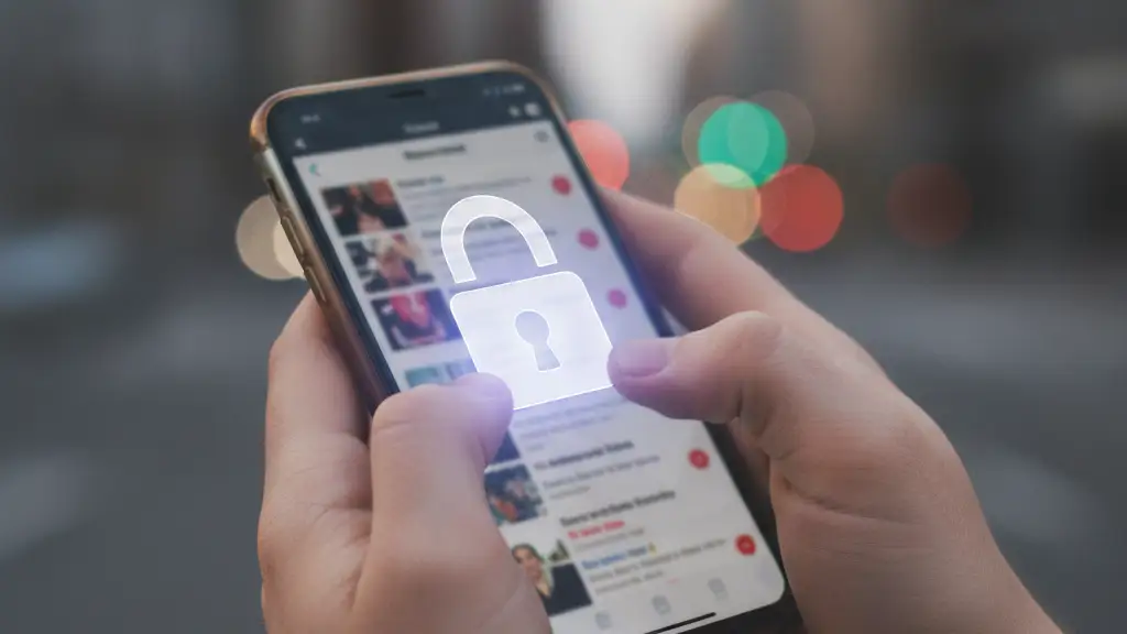 Hands holding a smartphone with a digital padlock icon on the screen.