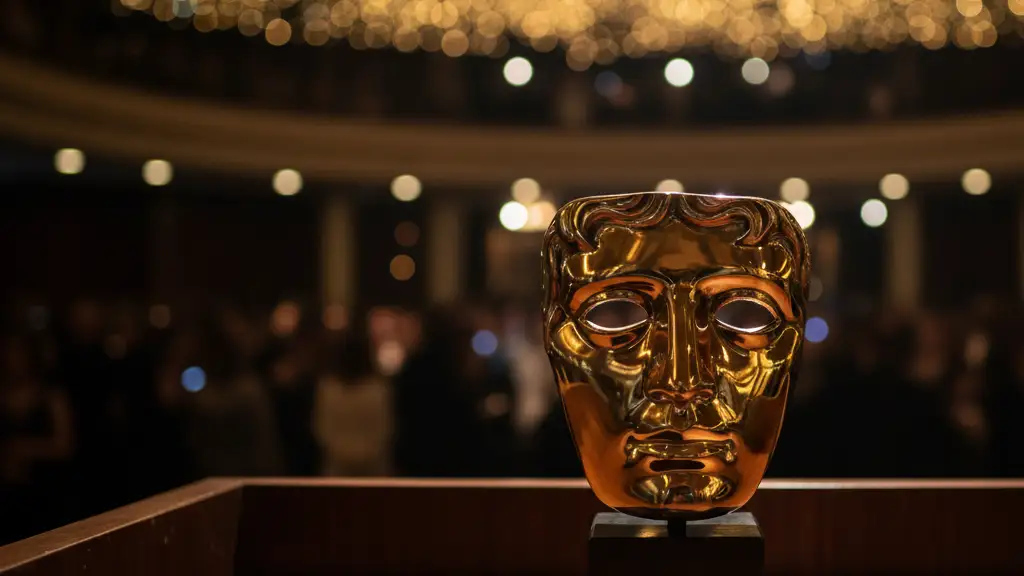 Golden BAFTA mask award on a dark podium, blurred elegant background.
