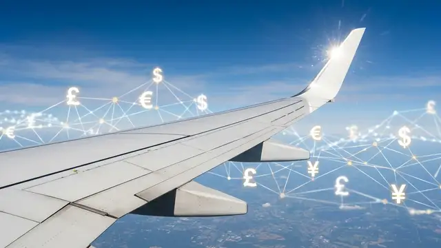Airplane wing against blue sky, with subtle financial symbols in background.