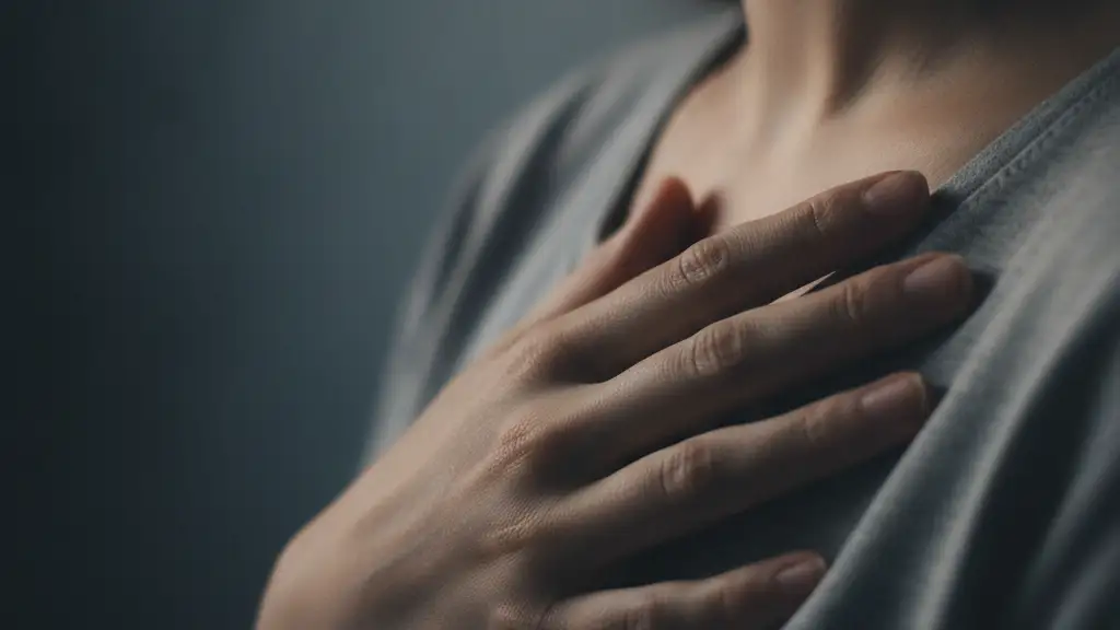 Woman's hand gently touching her chest, suggesting self-examination.