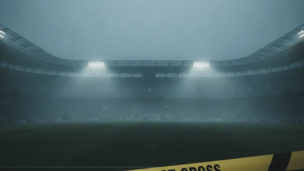 Yellow police tape in foreground, blurred football stadium lights in misty background.