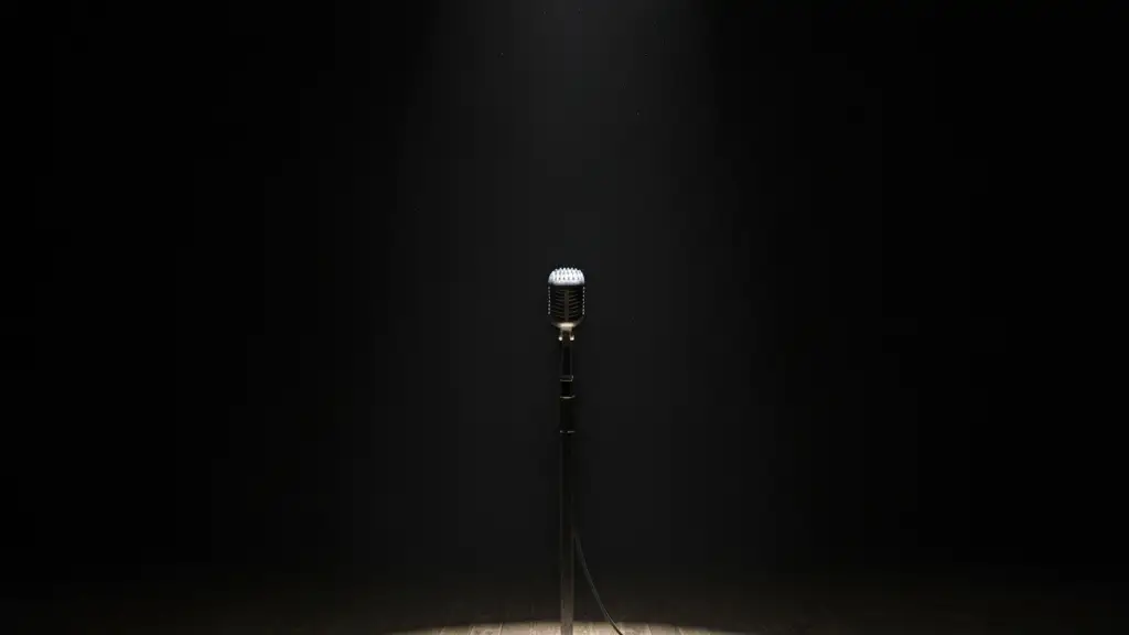 A lone vintage microphone stand under a single spotlight on an empty, dark stage.
