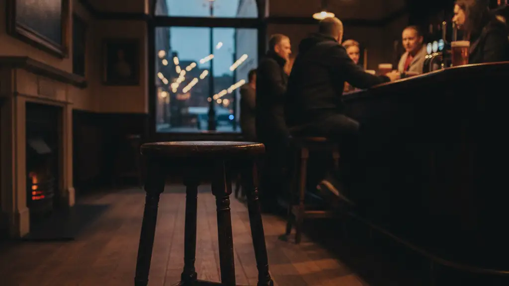 Empty bar stool in a dimly lit, traditional British pub.