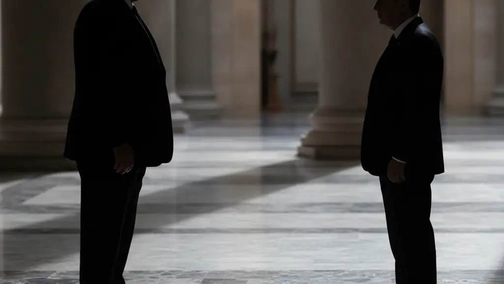 Silhouettes of two leaders, one larger, one smaller, standing apart in a grand hall.