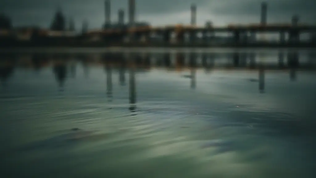 Murky green water with industrial reflections, suggesting pollution.