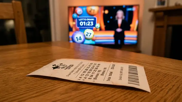 A close-up of a lottery ticket on a wooden table with a blurred background.