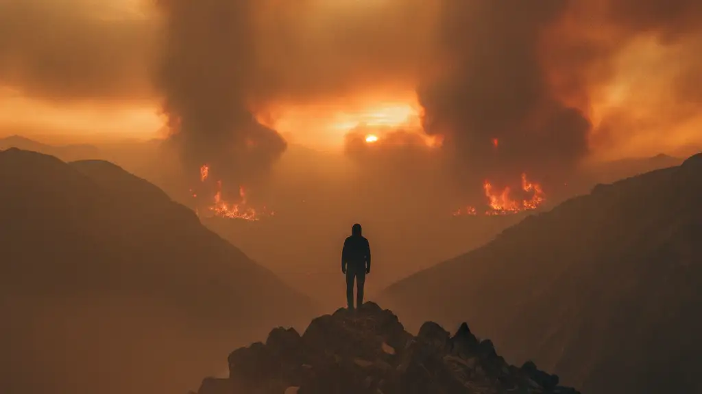 A lone figure silhouetted against a smoke-filled, orange sky from distant wildfires.