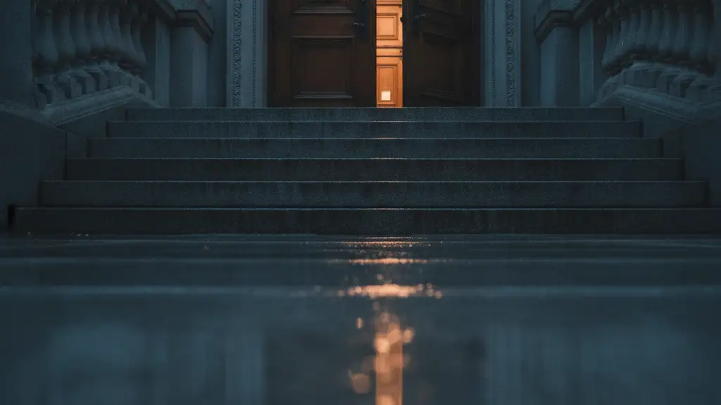 Grand courthouse steps, slightly ajar door, reflecting distant streetlights on wet stone.