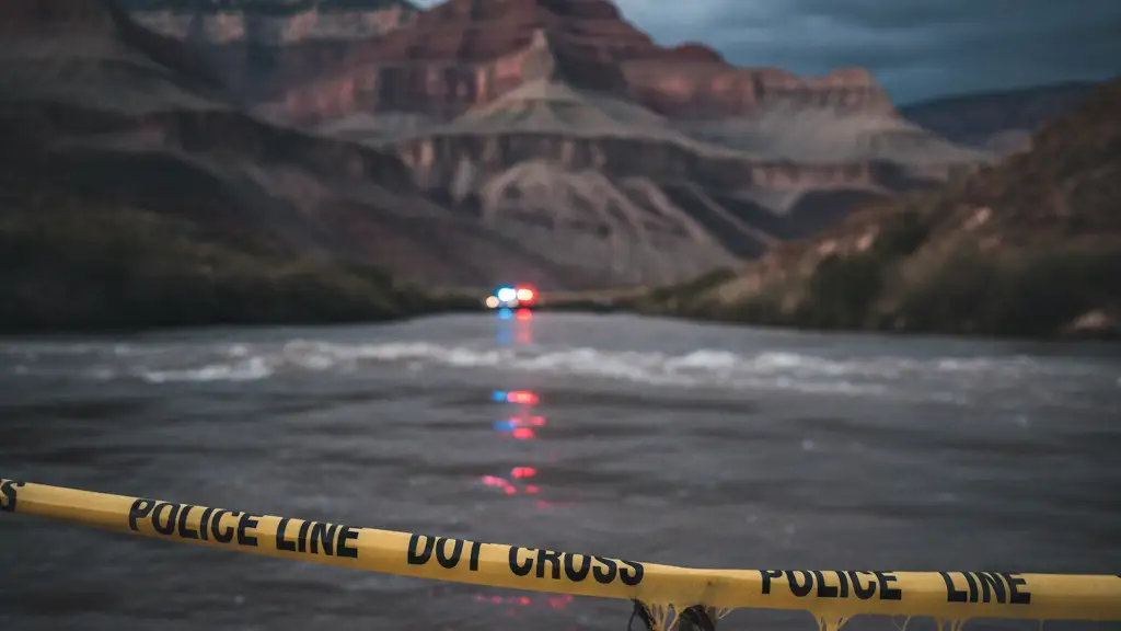 Police tape partially submerged in floodwaters in the Grand Canyon.