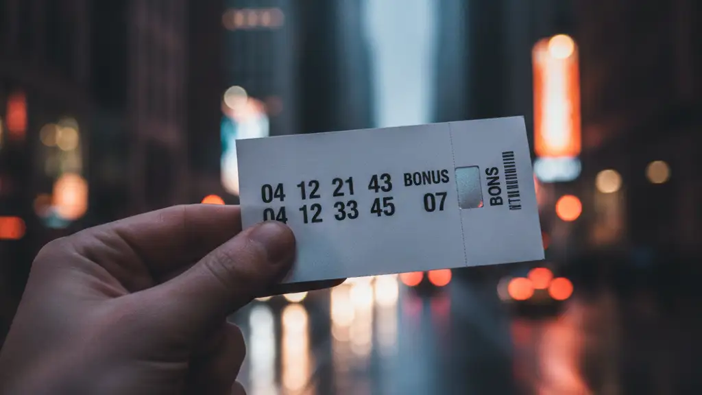 A lottery ticket held by fingers, with a blurred city street in the background.