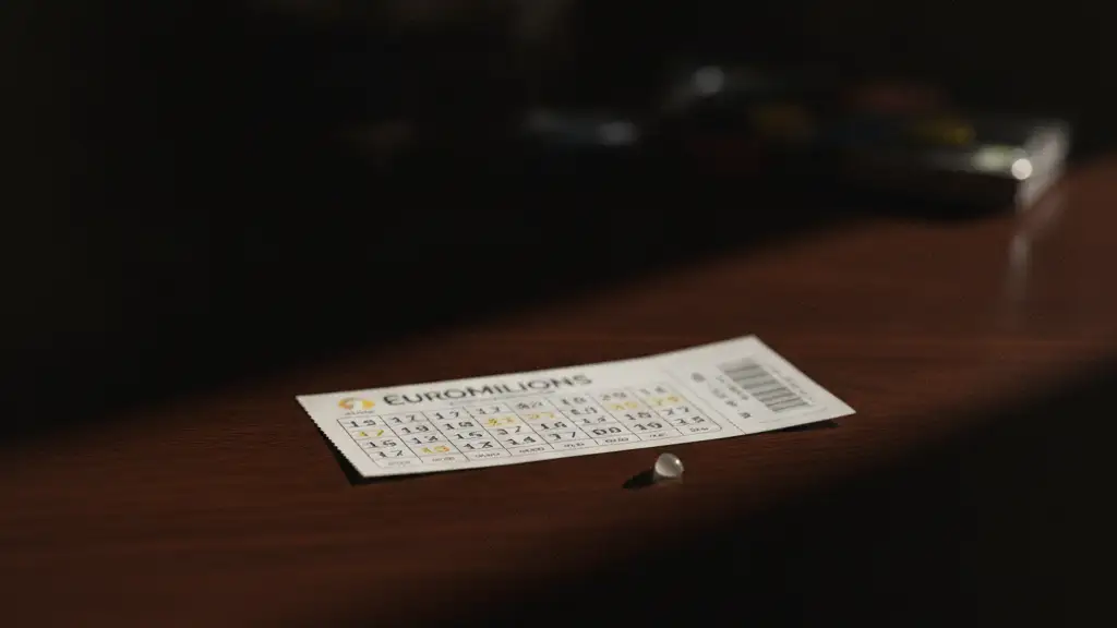 A single, pristine EuroMillions lottery ticket on a dark, polished mahogany table.