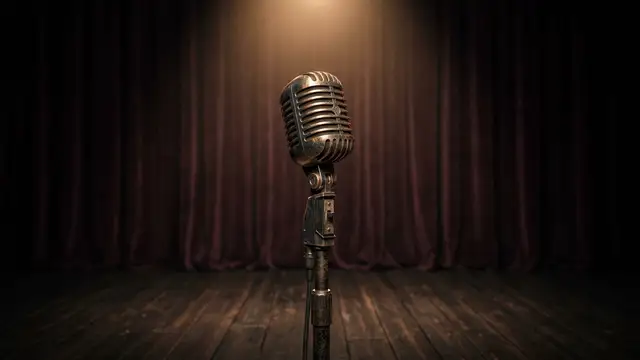 Vintage microphone on an empty, spotlighted stage, dark velvet curtain background.
