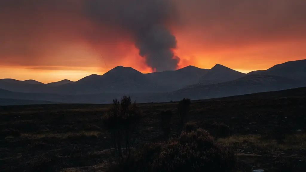 Smoky haze over the vast, rugged landscape of the Scottish Cairngorms at dusk.