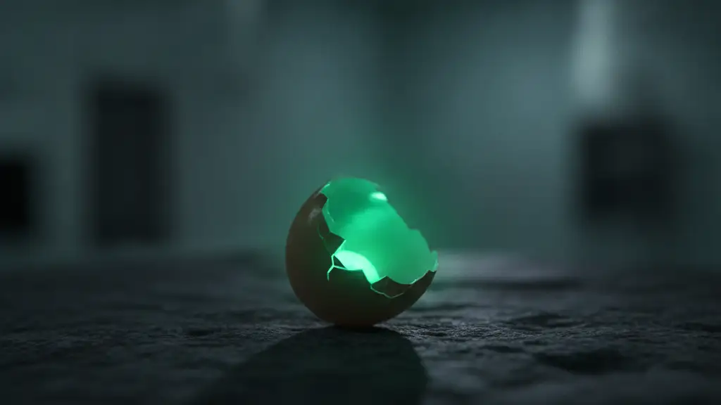 A single, cracked eggshell with a subtle green glow, on a dark surface.